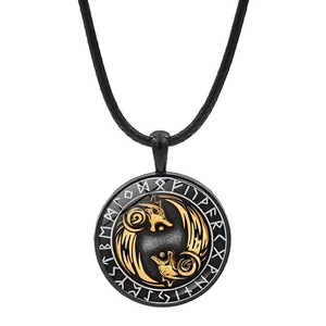 Detail of Viking dual wolf pendant with gold relief heads and silver runic alphabet