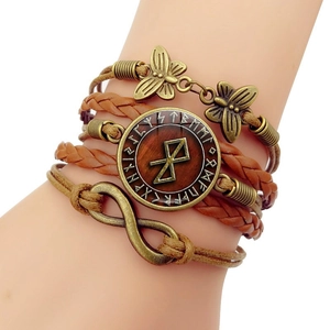 Detail view of multi-layer Viking leather bracelet with infinity charm and butterfly accents