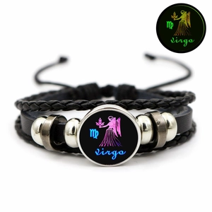 Detailed view of layered leather bracelet with Virgo zodiac glass bead and glow effect
