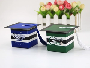 Detail of graduation cap gift boxes with silk tassels and Congrats Grad typography