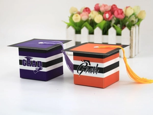 Detailed view of graduation cap candy boxes with tassels and striped grad gift patterns