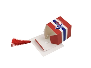 Detail of a folded graduation cap gift box featuring red tassels and Congrats Grad text