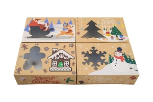 Detail view of four kraft Christmas cookie boxes with transparent windows and festive designs