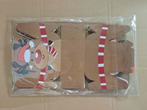 Flat lay of reindeer pattern Christmas muffin gift boxes in unfolded cardboard state