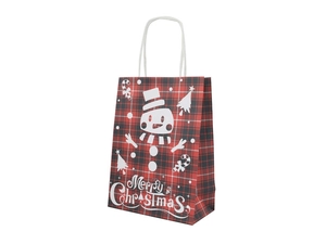 Close-up of red plaid Christmas kraft paper gift bag with snowman and tree patterns