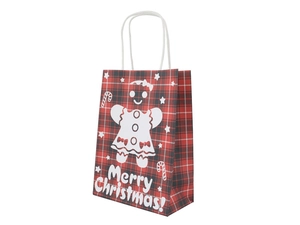 Detail of red and black plaid Christmas paper bag with white gingerbread man design