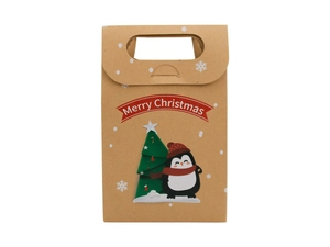 Detail of kraft paper Christmas gift bag featuring penguin, tree, and Merry Christmas text