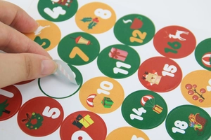 Macro view of Christmas advent calendar stickers with festive elk and wreath designs