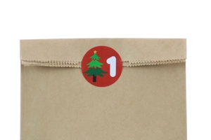 Brown kraft paper bag detail with red Christmas tree sticker and number one seal