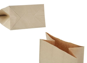 Detail of kraft paper bag showing the flat bottom fold and zigzag serrated top edge