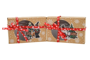 Close-up of kraft Christmas boxes with transparent window and red snowflake ribbon details
