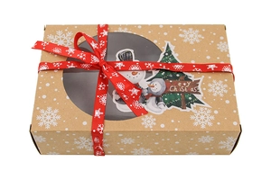Detail of kraft Christmas gift box with clear window, red ribbon and festive stickers