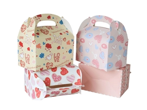 Detail of assorted Valentine cardboard gift boxes with heart patterns and handles