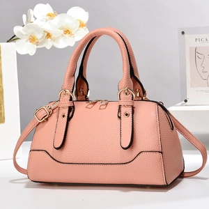 Pink lychee texture leather pillow bag with gold hardware and removable shoulder strap