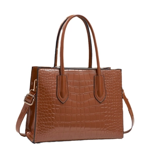 Brown crocodile embossed patent leather tote bag with glossy finish and top handles
