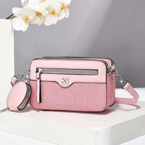 Pink patchwork crossbody camera bag with knitted texture and a small coin purse charm
