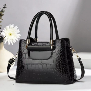 Fashionable black faux crocodile skin handbag with top handles and adjustable shoulder strap