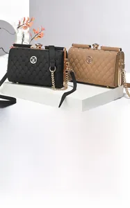 Detail of heart-quilted leather handbags with rhinestone clasps in black and khaki colors