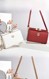 Glossy patent leather handbags with sparkling rhinestone clasps and round metal logos