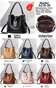 Macro shot of stone patterned leather bucket bags with D-shaped metal pendant hardware