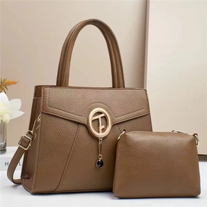 Detail of brown litchi pattern leather tote bag and pouch with gold metal hardware