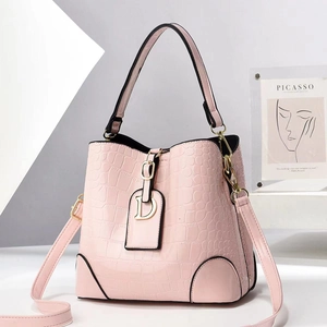 Pink faux croc leather bucket bag with gold D-charm and adjustable shoulder strap