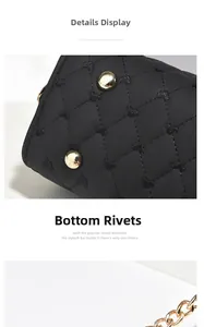 Detail view of heart-quilted black leather bag with gold base studs and chain