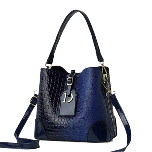 Blue gradient crossbody bag with crocodile texture and golden D pendant detail