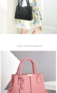 Detail view of large tote bags in black and pink with textured leather and gold hardware