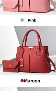 Close-up of pink and wine red leather tote bag set with pebble grain and gold hardware