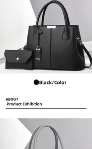 Detail of black lychee grain leather tote bag set with gold hardware and envelope pouch