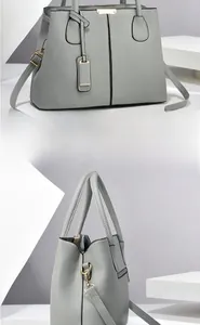 Macro view of grey pebble leather tote with brushed gold hardware and dual handles