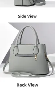 Detail view of grey litchi grain leather tote bag with gold zipper and dual handles