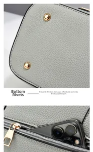 Detail of light gray tote bag with bottom protective rivets and functional back zipper pocket