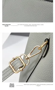 Close-up of golden metal buckle and magnetic clasp on grey litchi texture leather tote bag