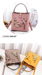 Détails de broderie florale et pendentif papillon sur le sac à main seau