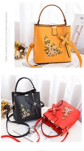 Détail de broderie florale et breloque papillon sur sacs à main jaune, noir et rouge