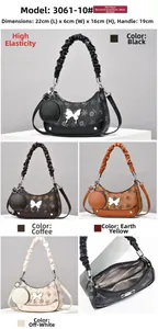 Detail view of printed shoulder bag with butterfly charm and matching coin purse