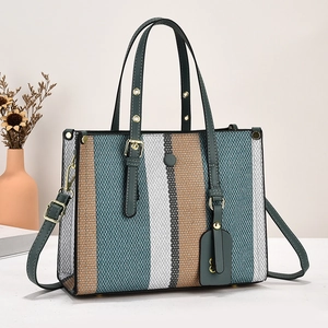 Large striped canvas tote bag with green leather trim and adjustable shoulder strap