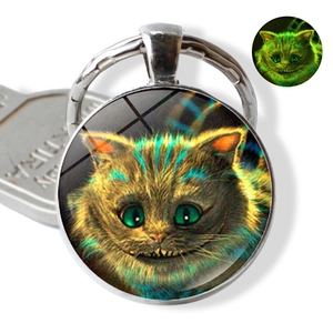 Glow-in-the-dark Cheshire Cat glass dome keychain with Alice in Wonderland design