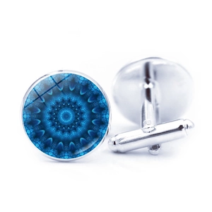 Close-up of silver cufflinks featuring a blue mandala pattern under glass crystal