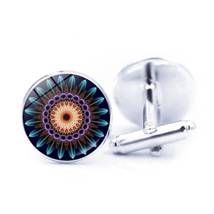 Detail of silver shirt cufflinks featuring geometric blue mandala pattern under glass dome
