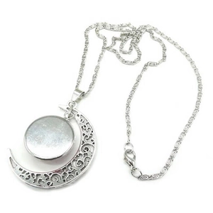 Silver crescent moon necklace with hollow floral pattern and peace sign pendant design