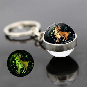 Luminous Aries zodiac glass ball keychain with silver metal ring and dark glow effect