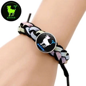 Dettaglio del bracciale intrecciato segno Ariete con ciondolo luminoso indossato al polso