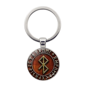 Détail macro du porte-clés boussole viking nordique avec dôme en verre et anneau argenté