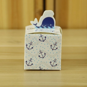 Close-up of nautical whale gift box with anchor pattern and blue dots for candy
