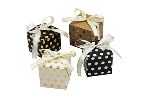 Detailed view of four assorted polka dot gift boxes with elegant white satin ribbons