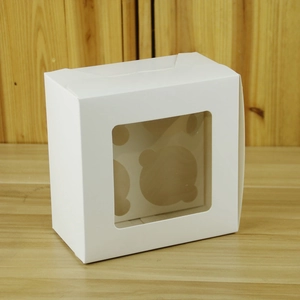 Macro shot of white cardboard cupcake box with window and 4-slot inner tray insert