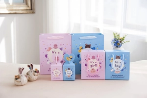 Dettaglio di sacchetti e scatole regalo per baby shower in rosa e blu con disegni